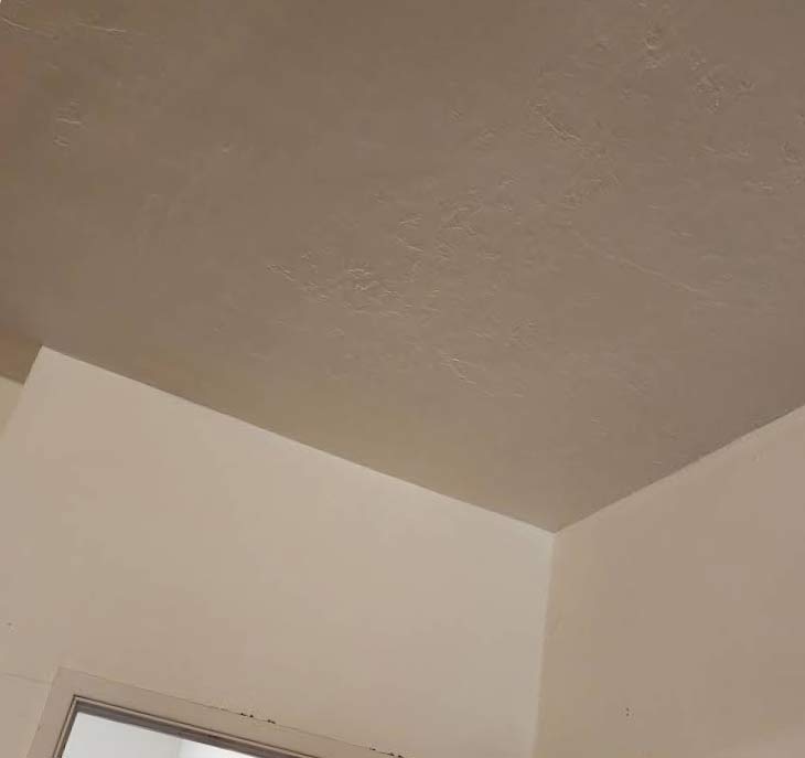 Seamless drywall repair and texture matching on residential ceiling after professional interior painting
