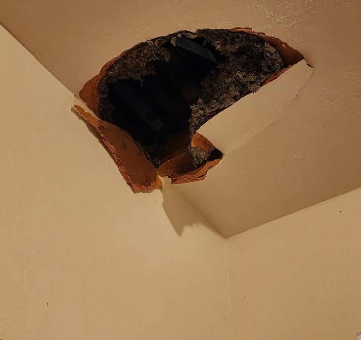 Large hole in textured ceiling requiring professional drywall repair and patching in Clovis CA