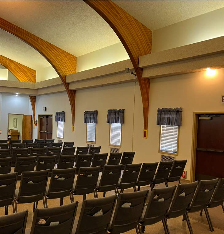 High-end retail interior painting in progress showing black tile floors protected by red rosin paper and walls masked for custom black graphic application